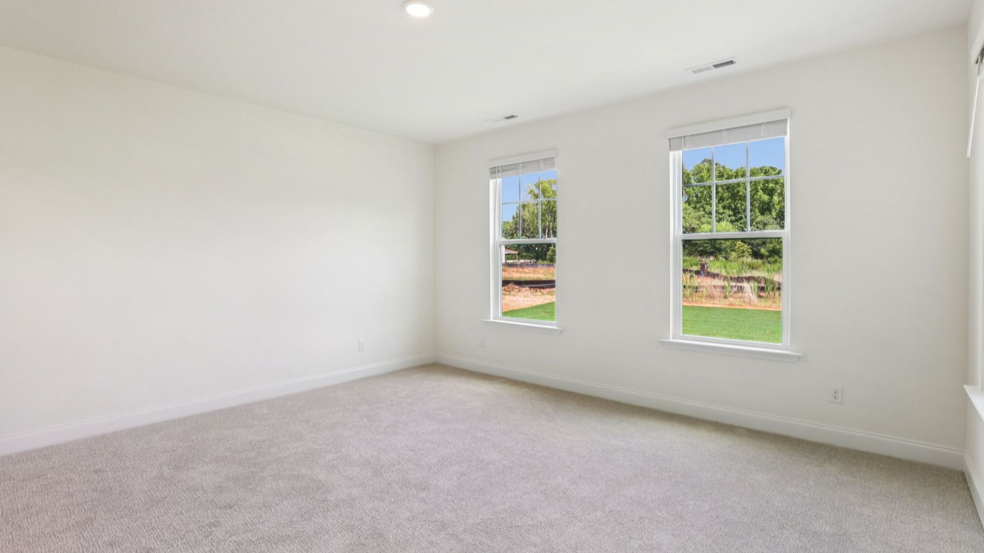 Pendleton home plan spacious first floor primary bedroom/suite with windows and attached bath