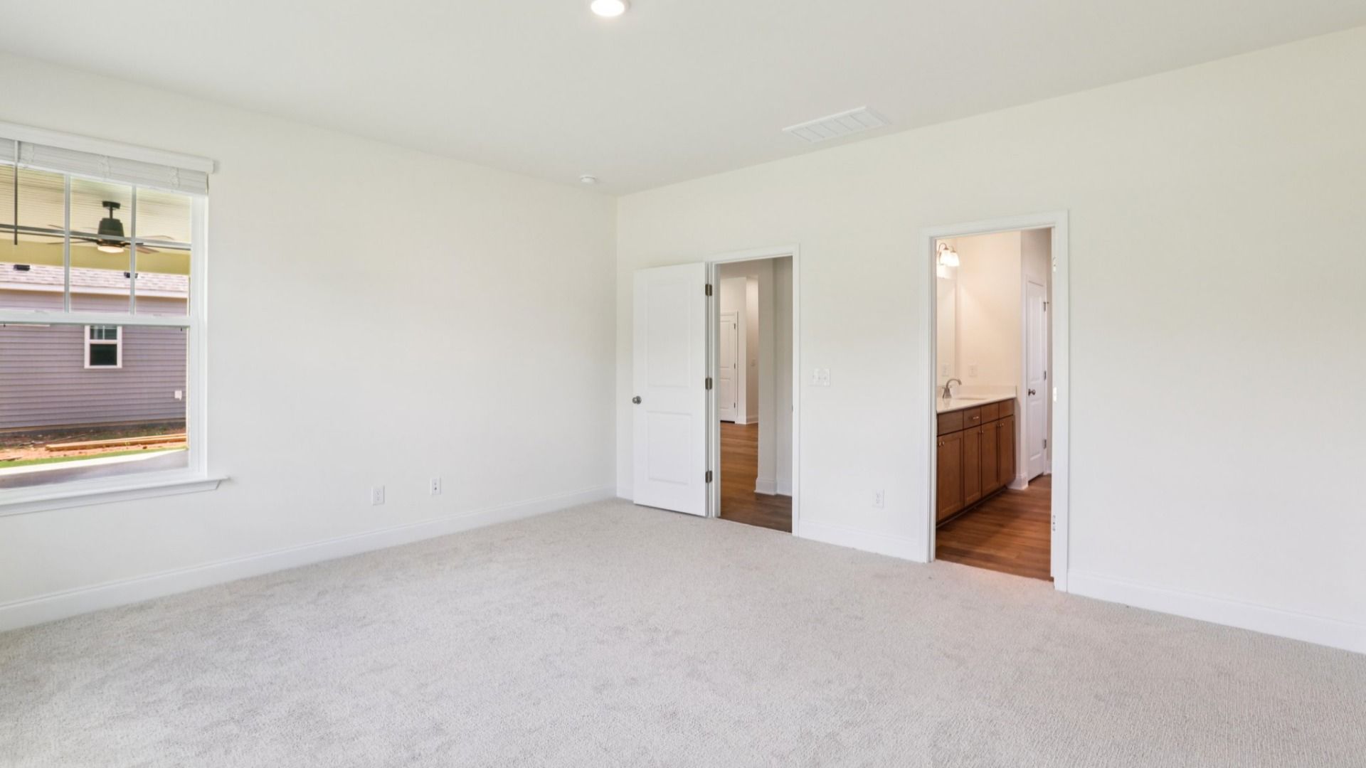 Pendleton home plan spacious first floor primary bedroom/suite with windows and attached bath