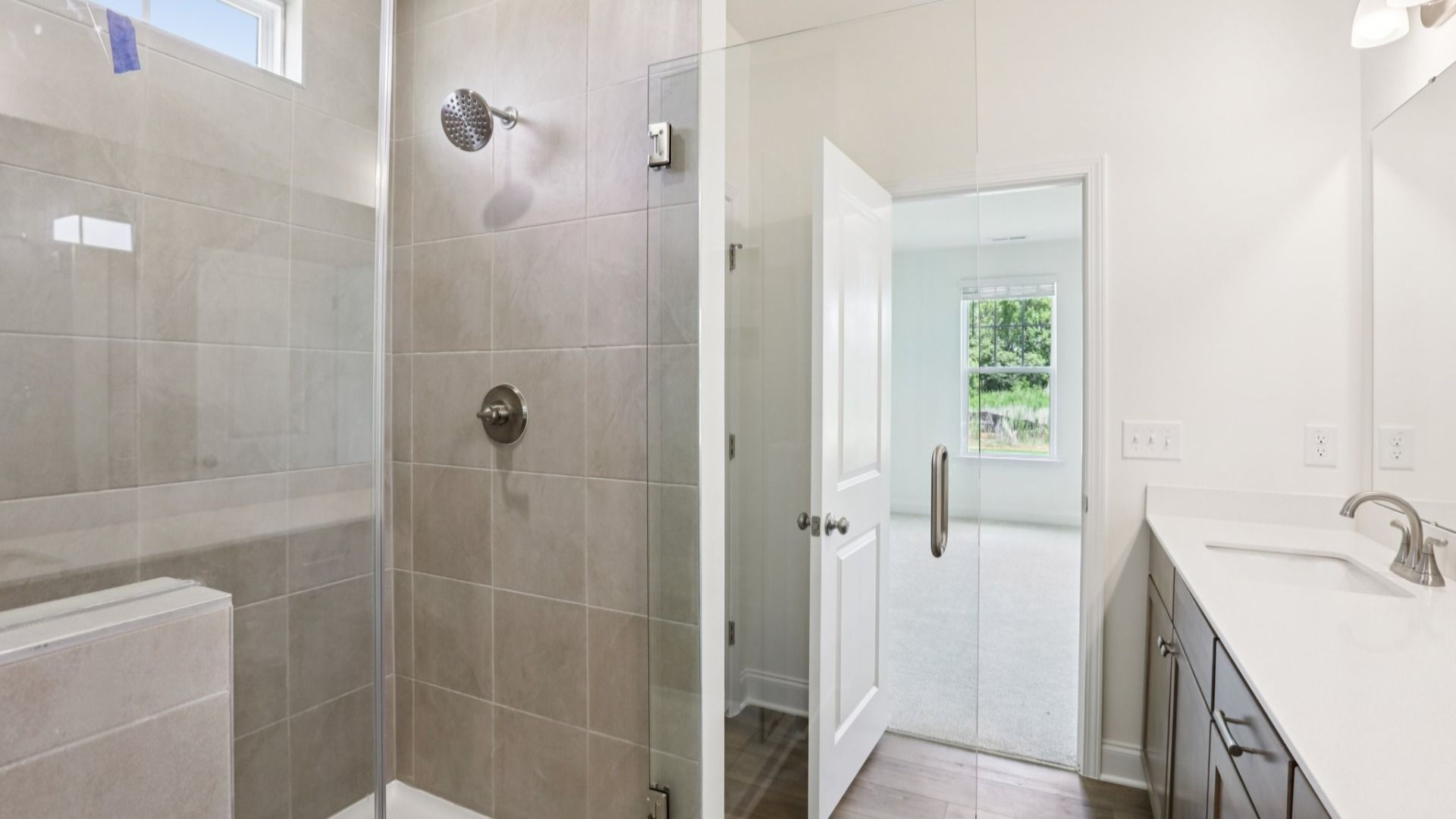 Pendleton home plan primary bathroom with tile shower, dual vanities and linen closet