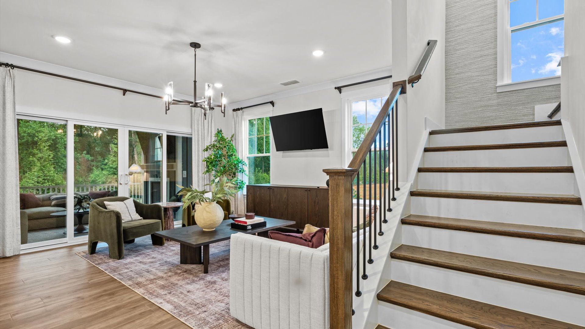 Pelham home plan staircase with open railing and family room/living space
