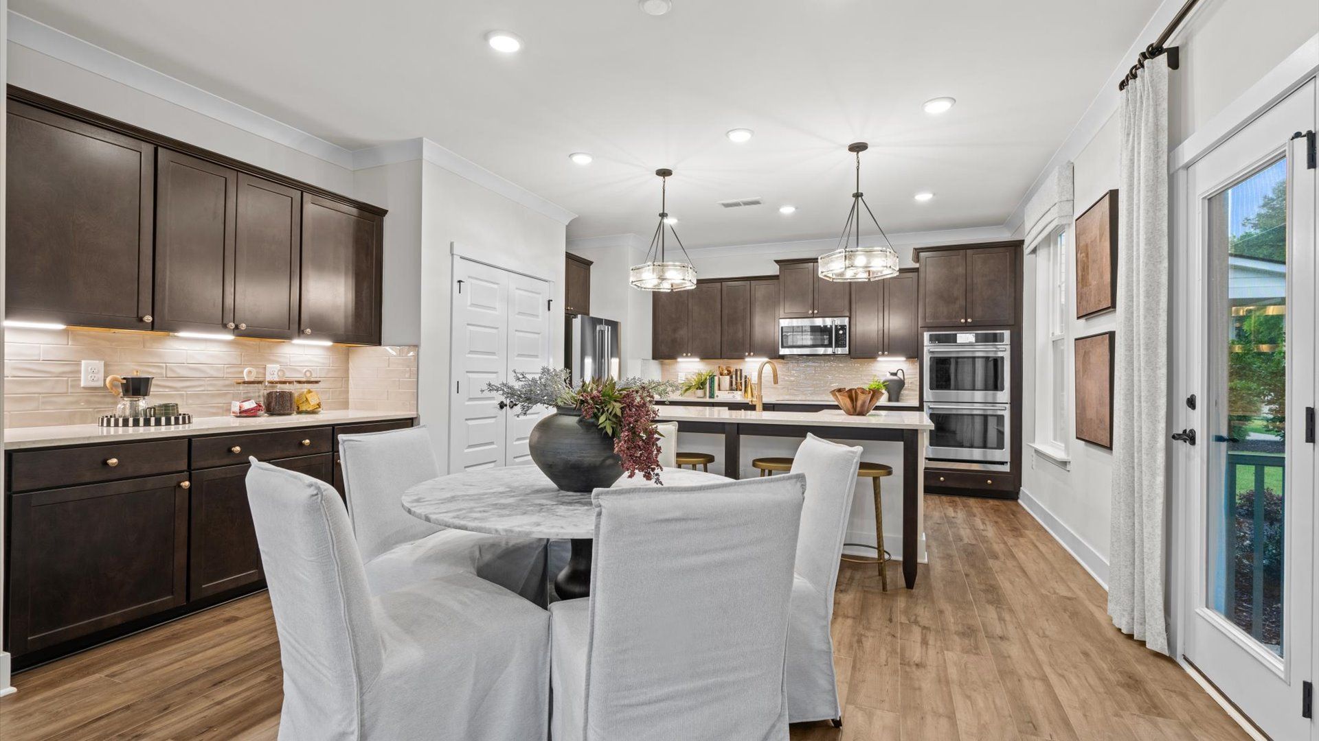 Pelham home plan open concept breakfast area, coffee station, and kitchen with island