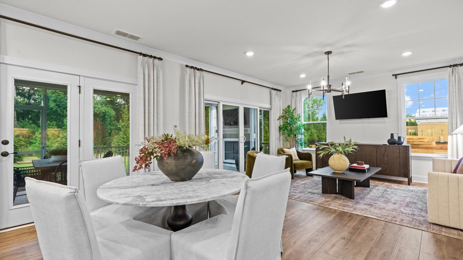 Pelham home plan open concept breakfast area and family room with 10' doors to screened porch