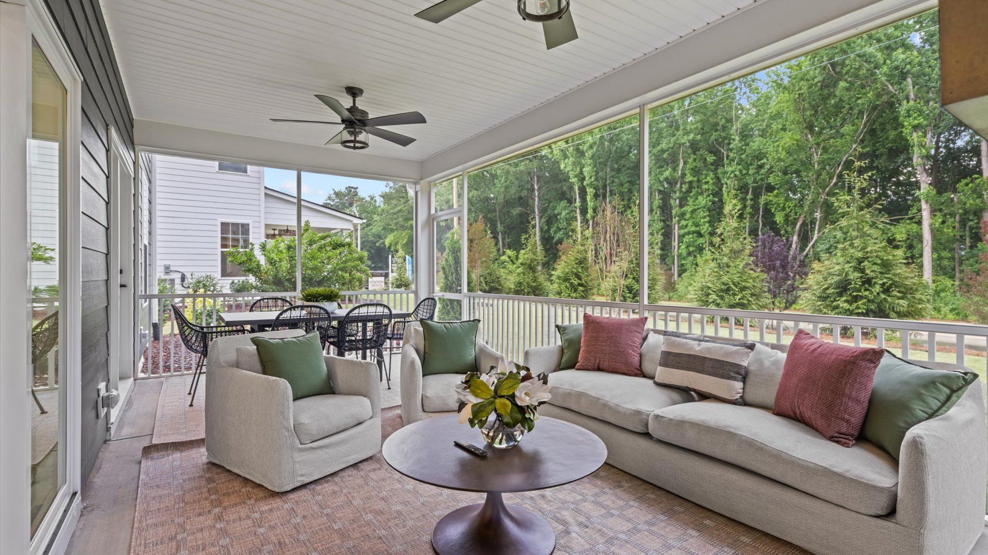 Pelham home plan large screened-in back porch with ceiling fans and exterior fireplace