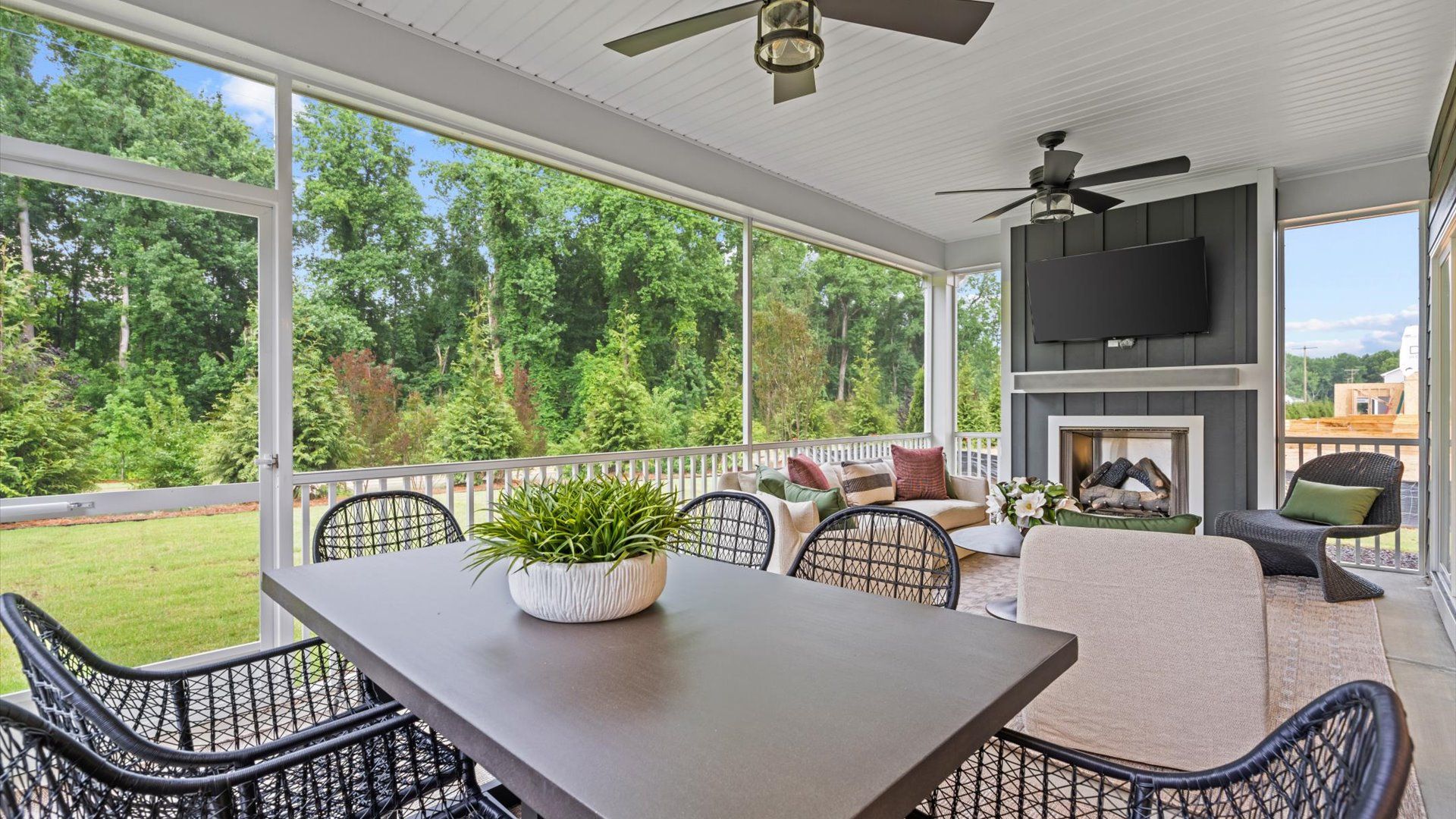 Pelham home plan large screened-in back porch with ceiling fans and exterior fireplace