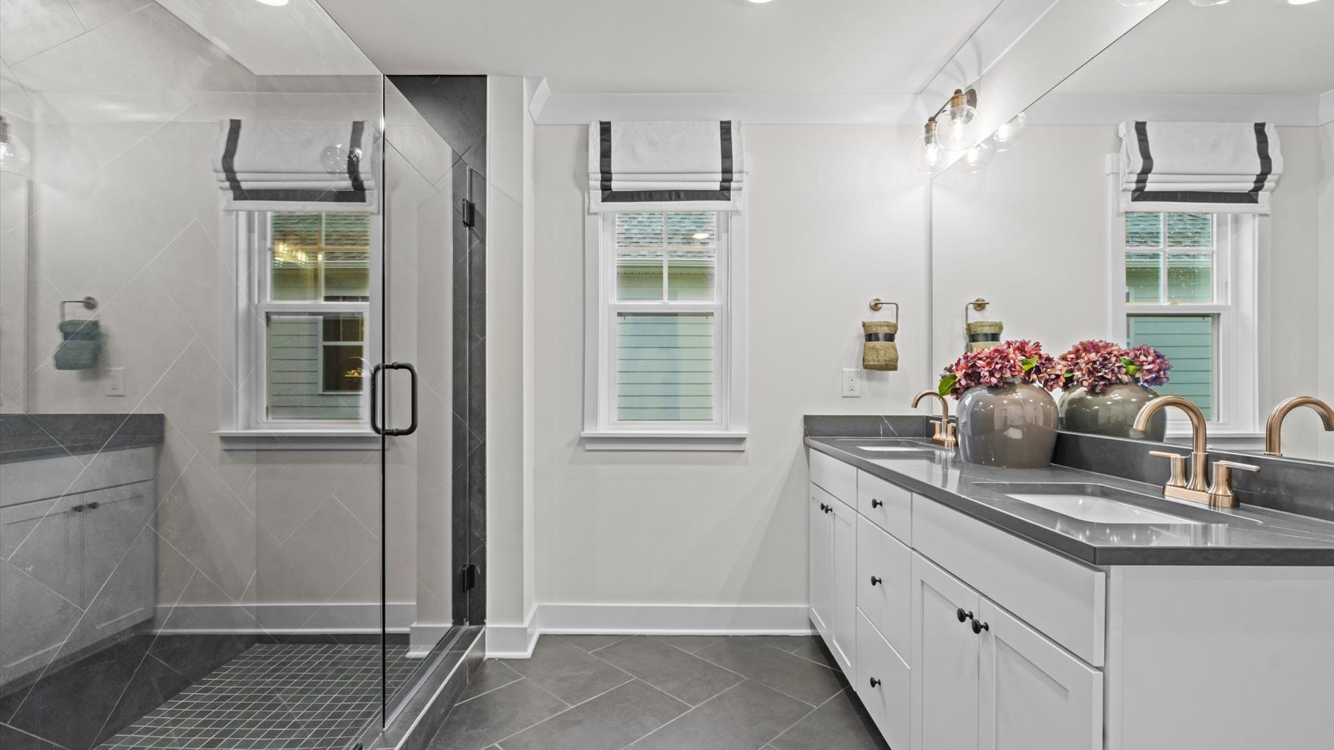 Pelham home plan primary bathroom with dual vanities and huge tile shower with dual shower heads