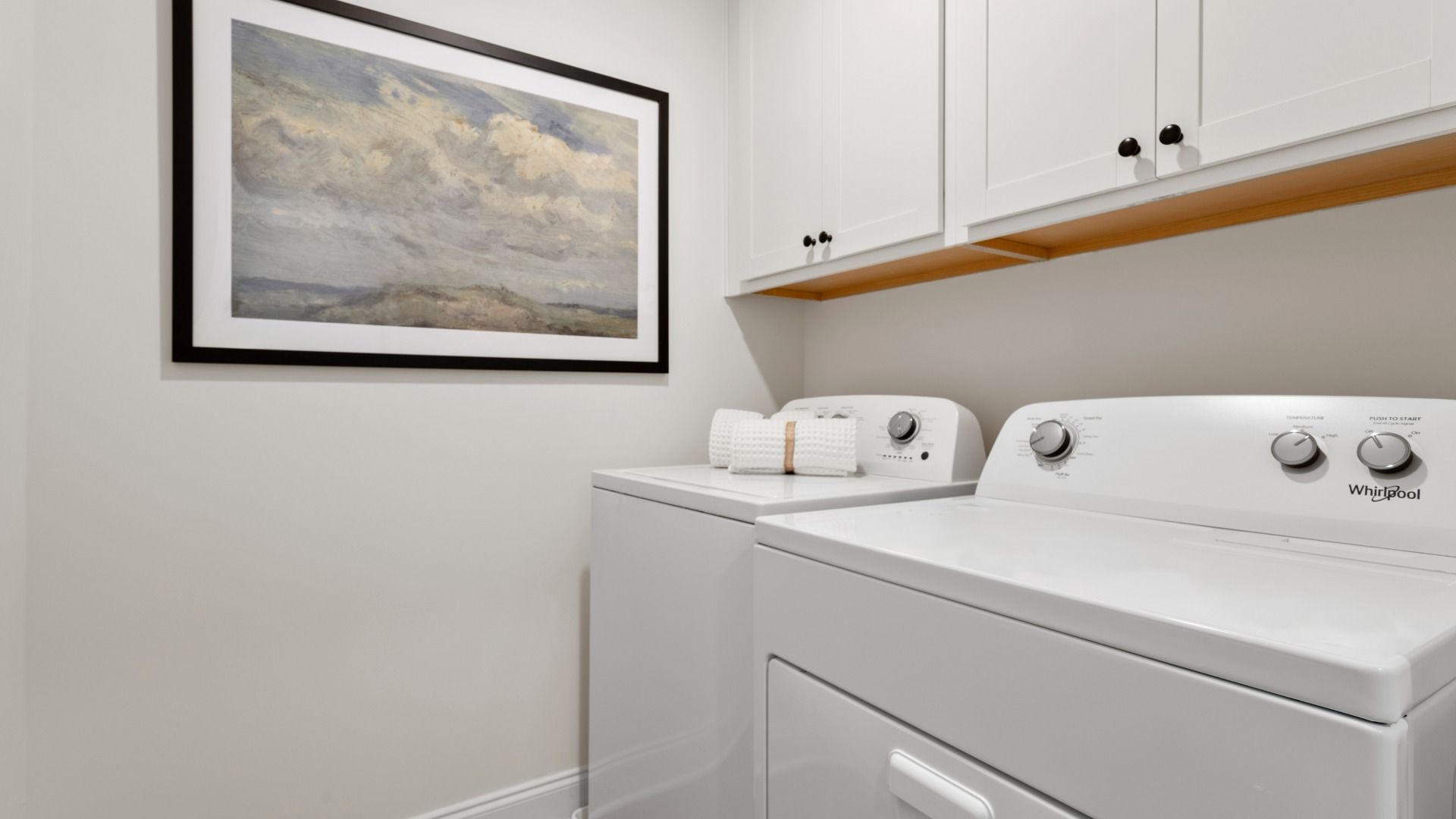 Stonefield home plan laundry room with cabinets for storage