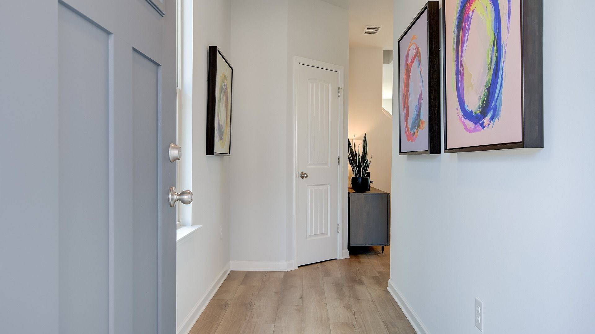 Welcoming interior entryway with high ceilings, coat closet, and open sightlines into main living area.