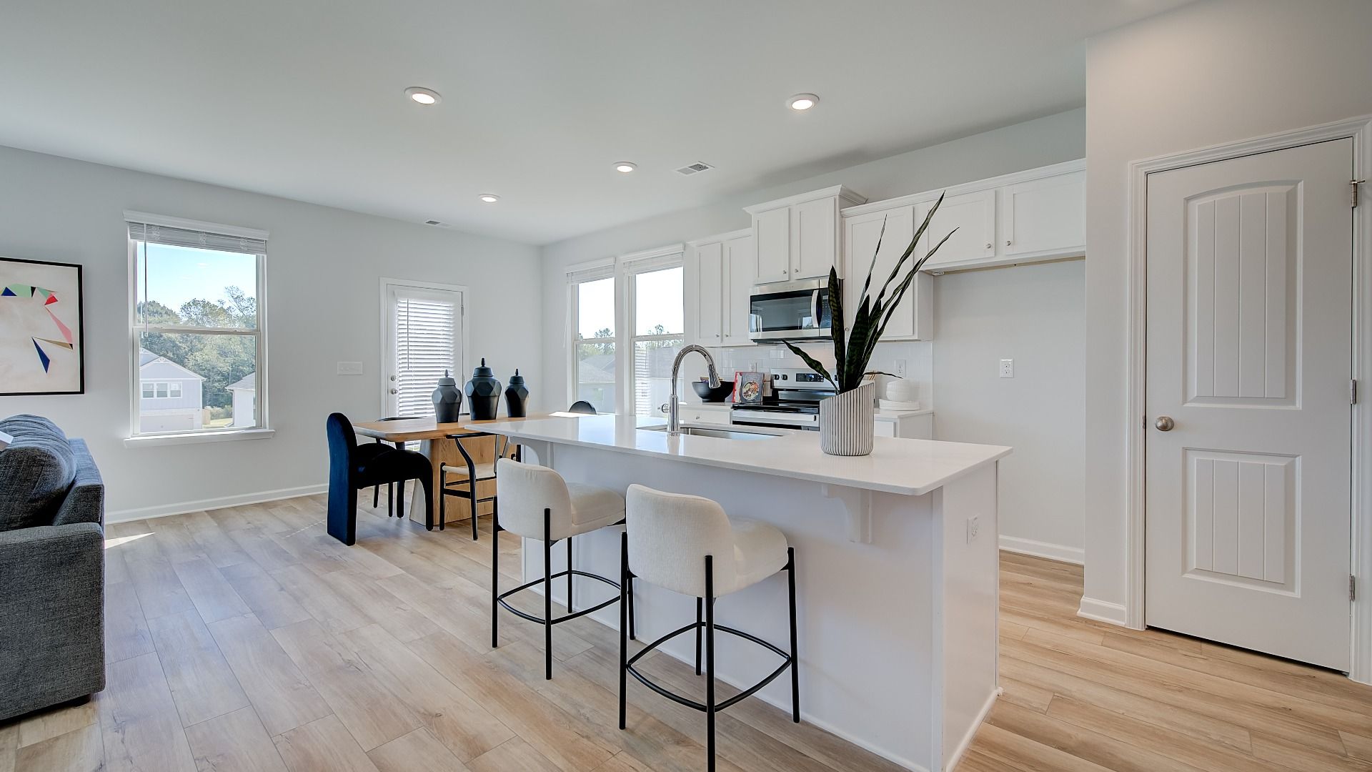Modern kitchen in new construction home with large island and quartz countertops.