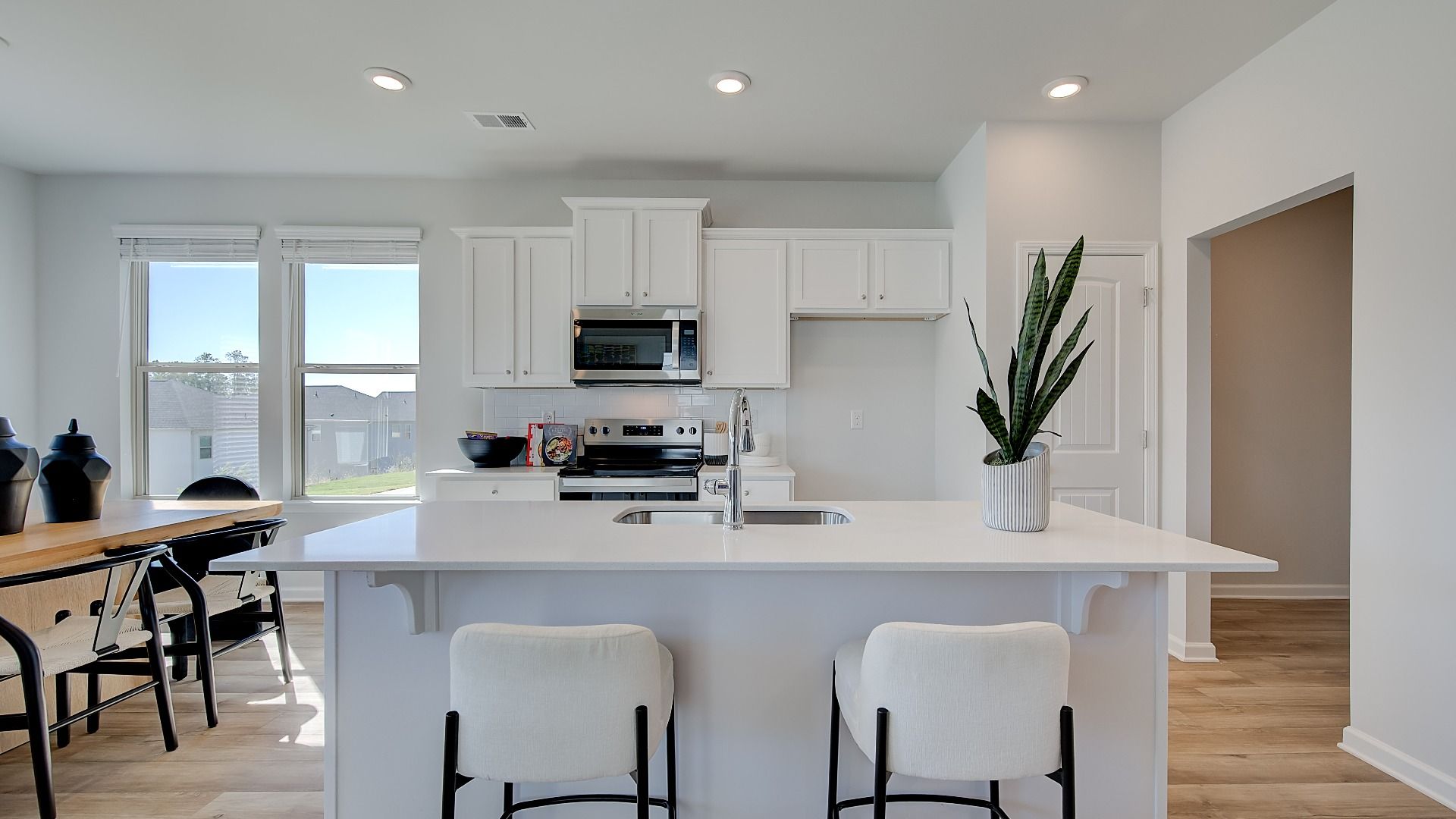 Modern kitchen in new construction home with large island and quartz countertops.