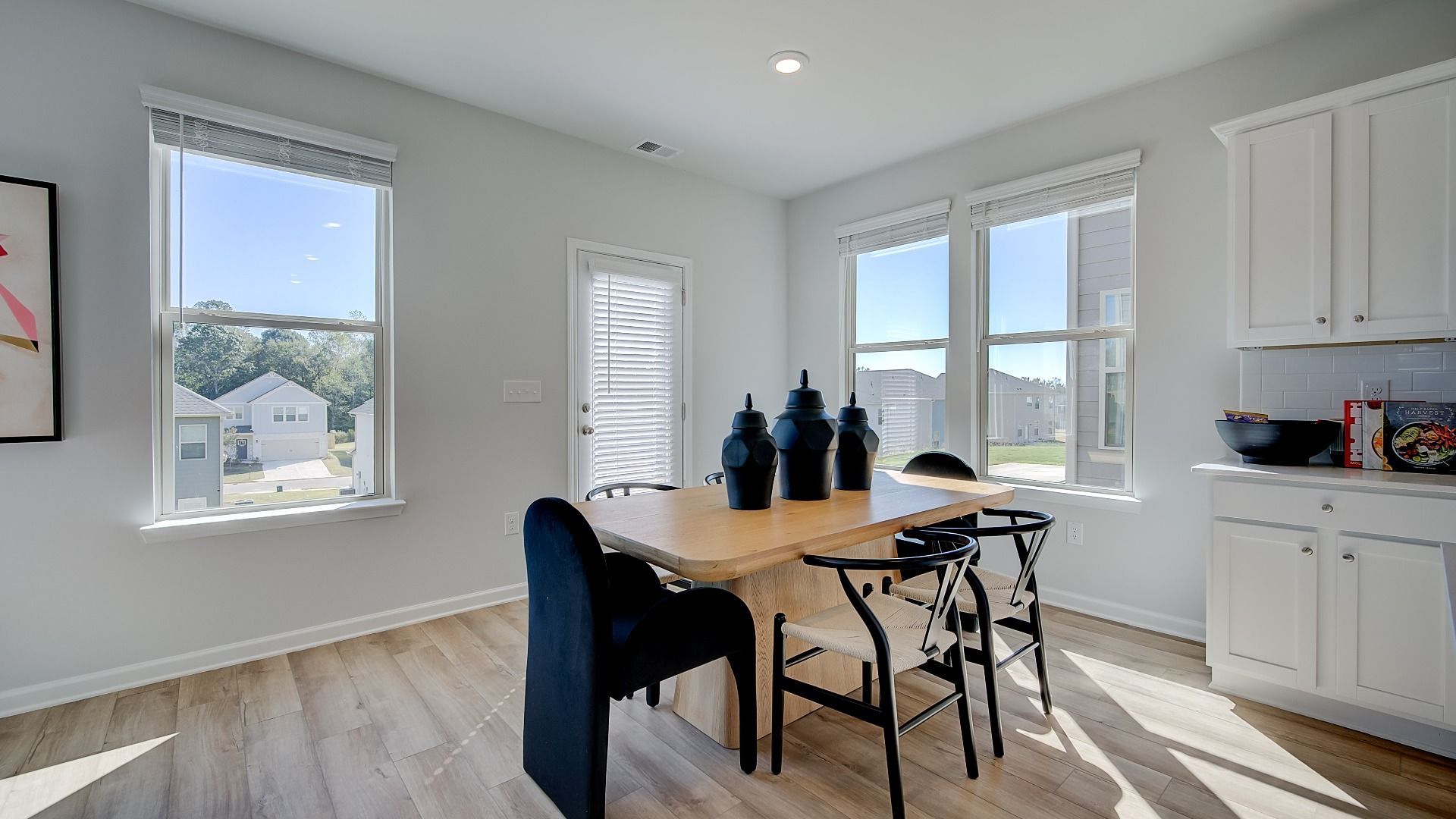 Open breakfast area in new construction home with expansive windows and natural light.