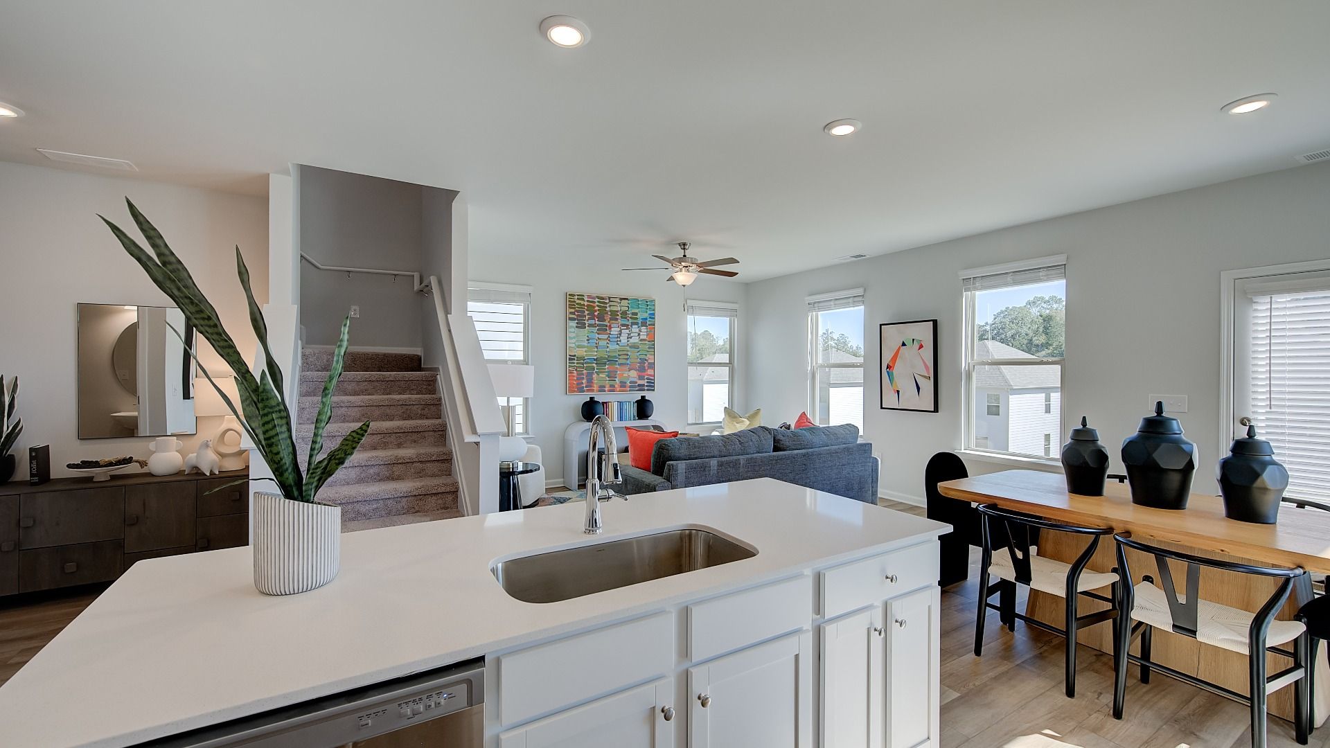 Open family room with abundant natural light and seamless flow to kitchen in new construction home.