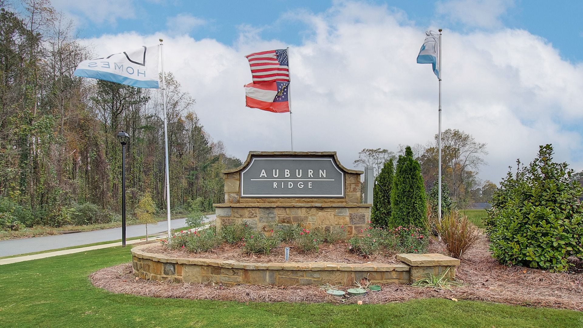 Stone entrnace monument welcoming residents and visitors to the Auburn Ridge Community in Riverdale, Georgia.