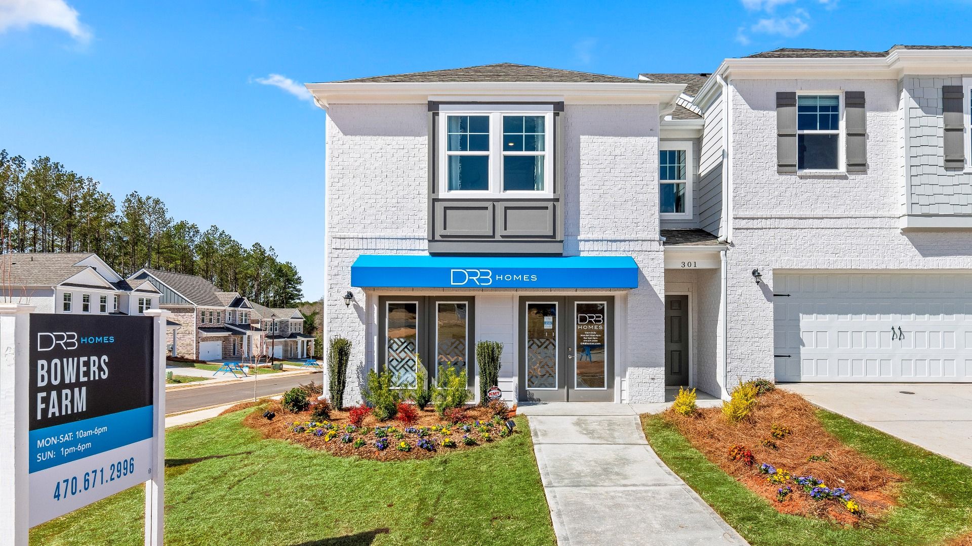 Model home exterior at Bowers Farm in McDonough, GA featuring modern townhome design and landscaped surroundings.