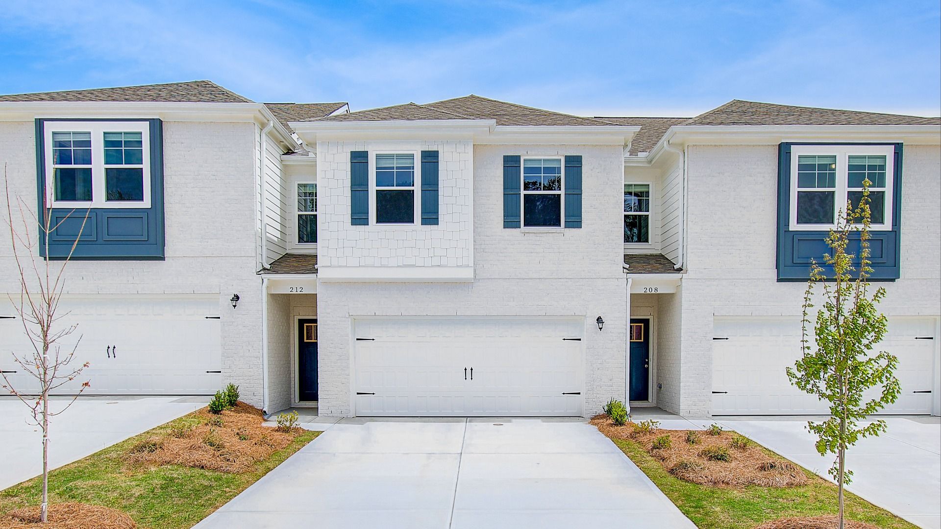 Austin exterior model home with modern design with shutters, and landscaped entry at Bowers Farm in McDonough, GA.