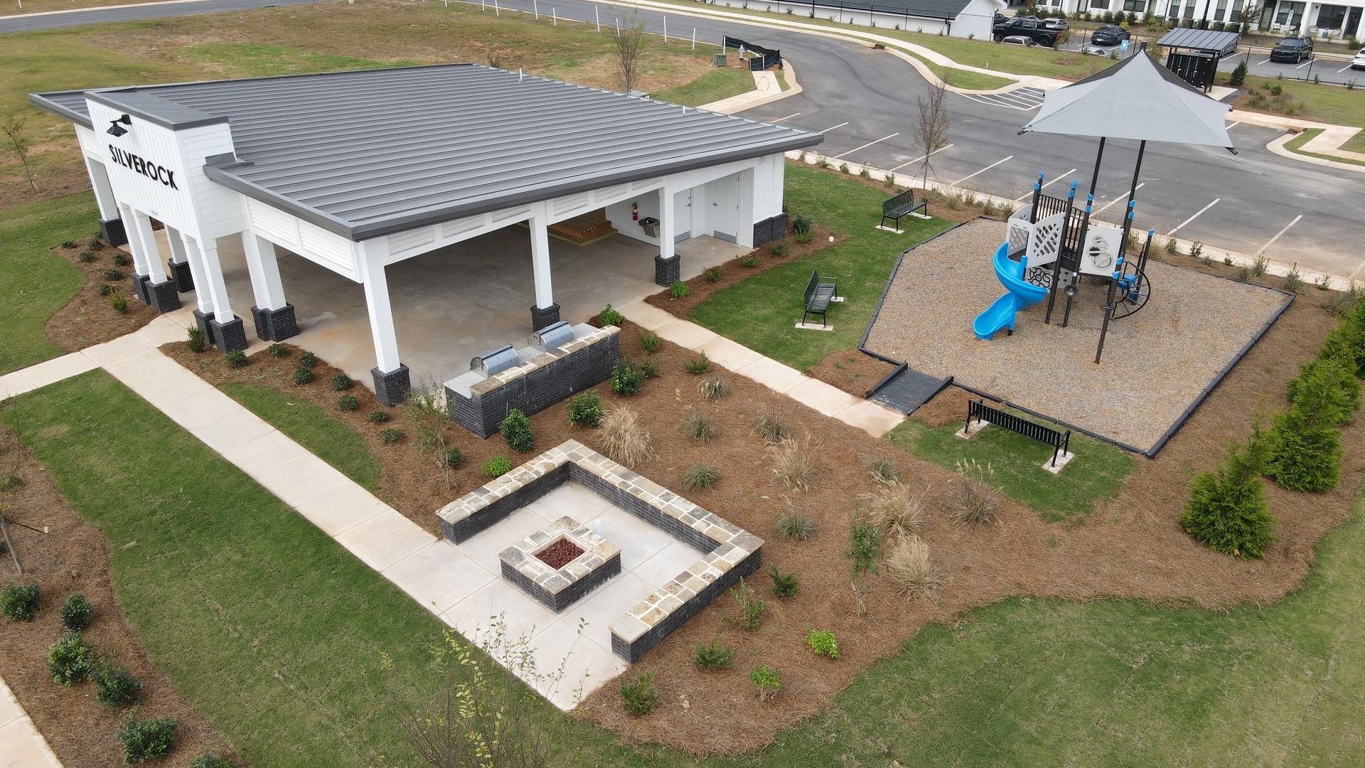 Community amenities featuring large pavilion, mulched playground, and oversized fireplace area at Silverock in McDonough, GA.