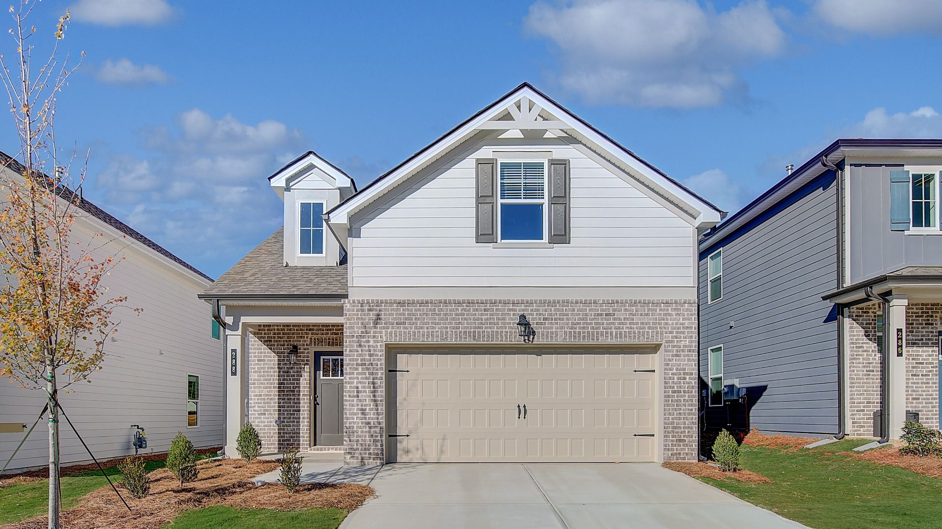 Charming single-family home in Conyers, GA featuring brick façade, covered porch, and attached garage.
