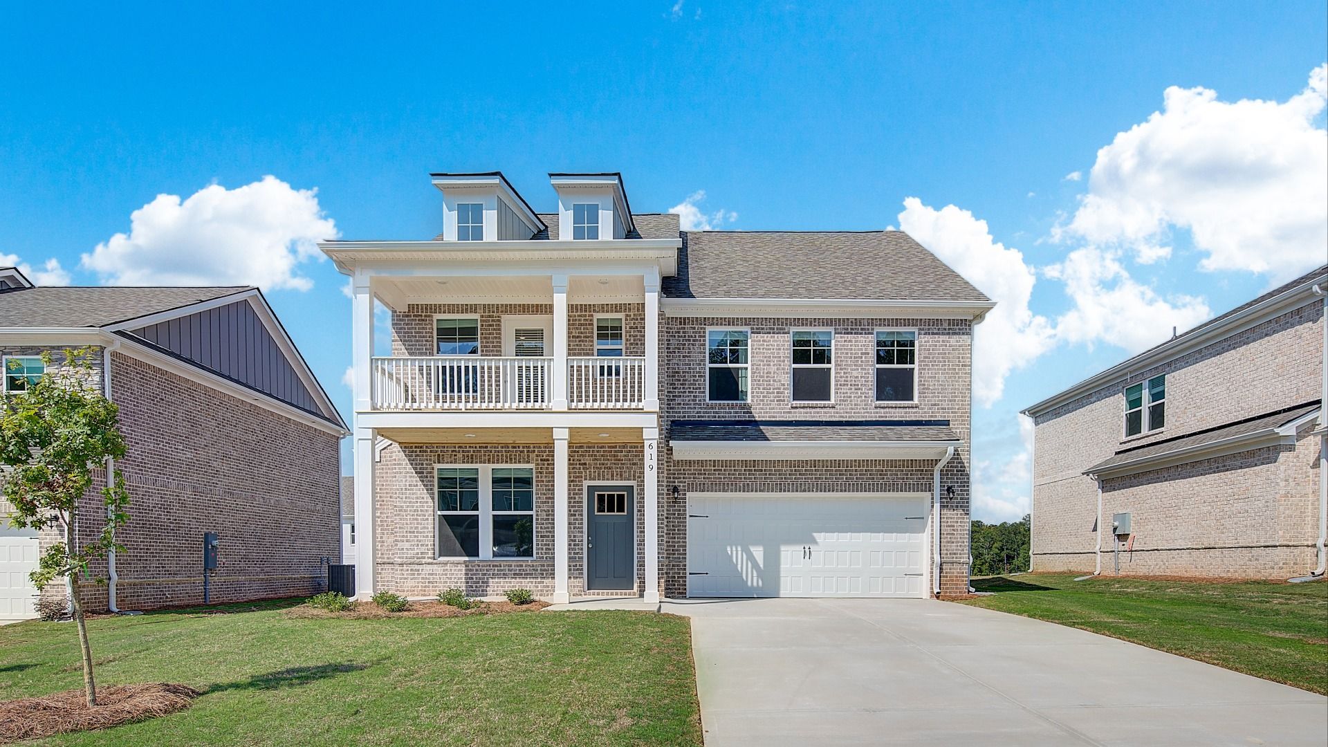 Pelham single-family home exterior at Bowers Farm featuring brick construction and balcony in McDonough, GA.