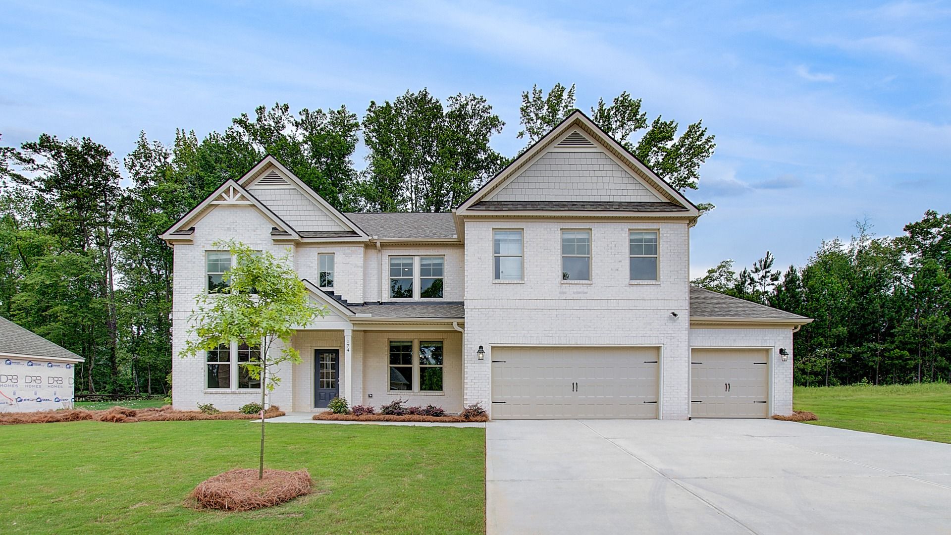 Clarity new construction single family home with four-sided brick exterior and three-car front entry garage in Hampton, GA.