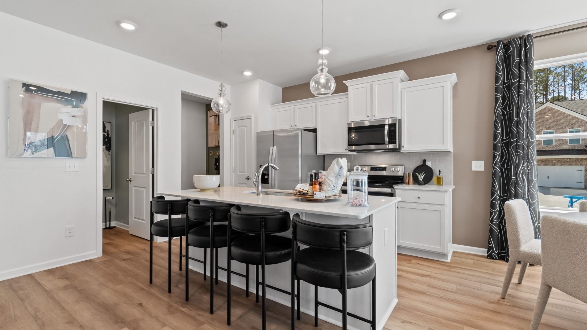 Modern kitchen at Bowers Farm with island seating, stainless appliances, and bright open concept space.