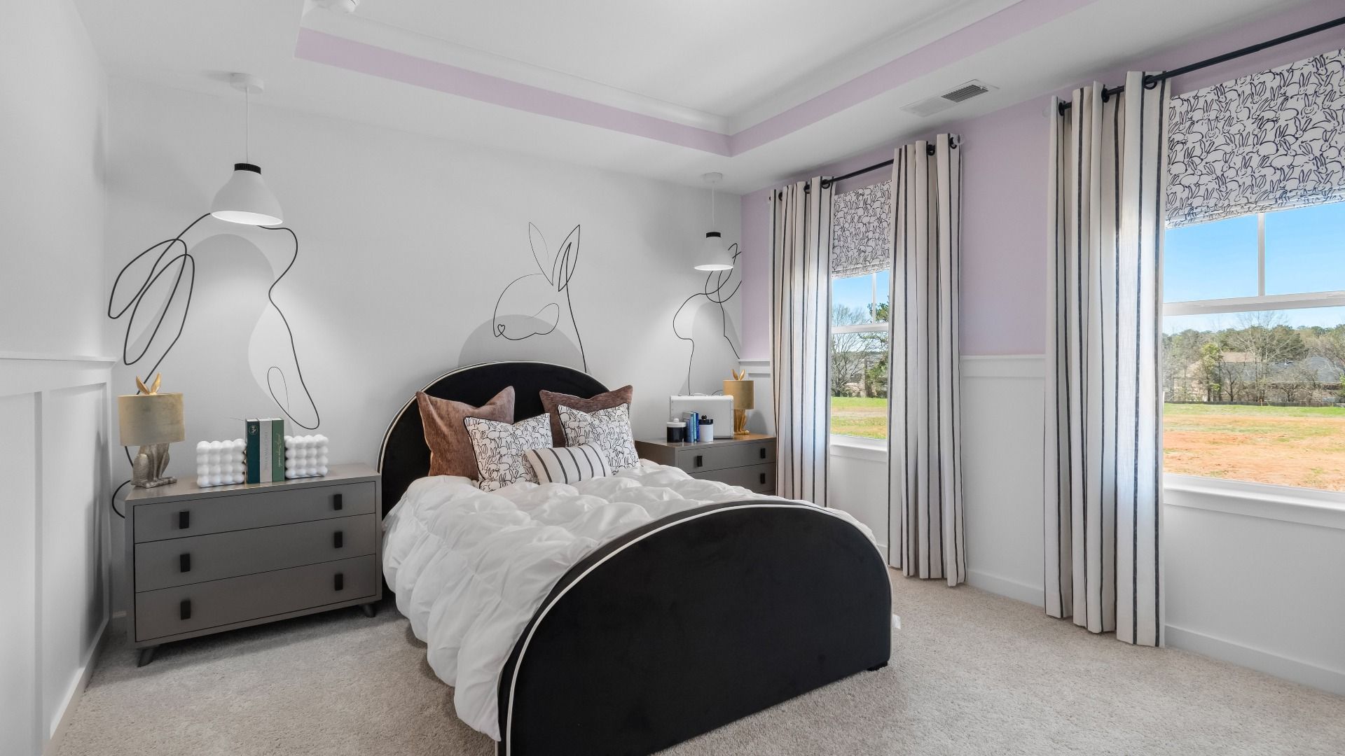 First-level secondary bedroom with large windows and tray ceiling at Cambria at Traditions in Hampton, GA.