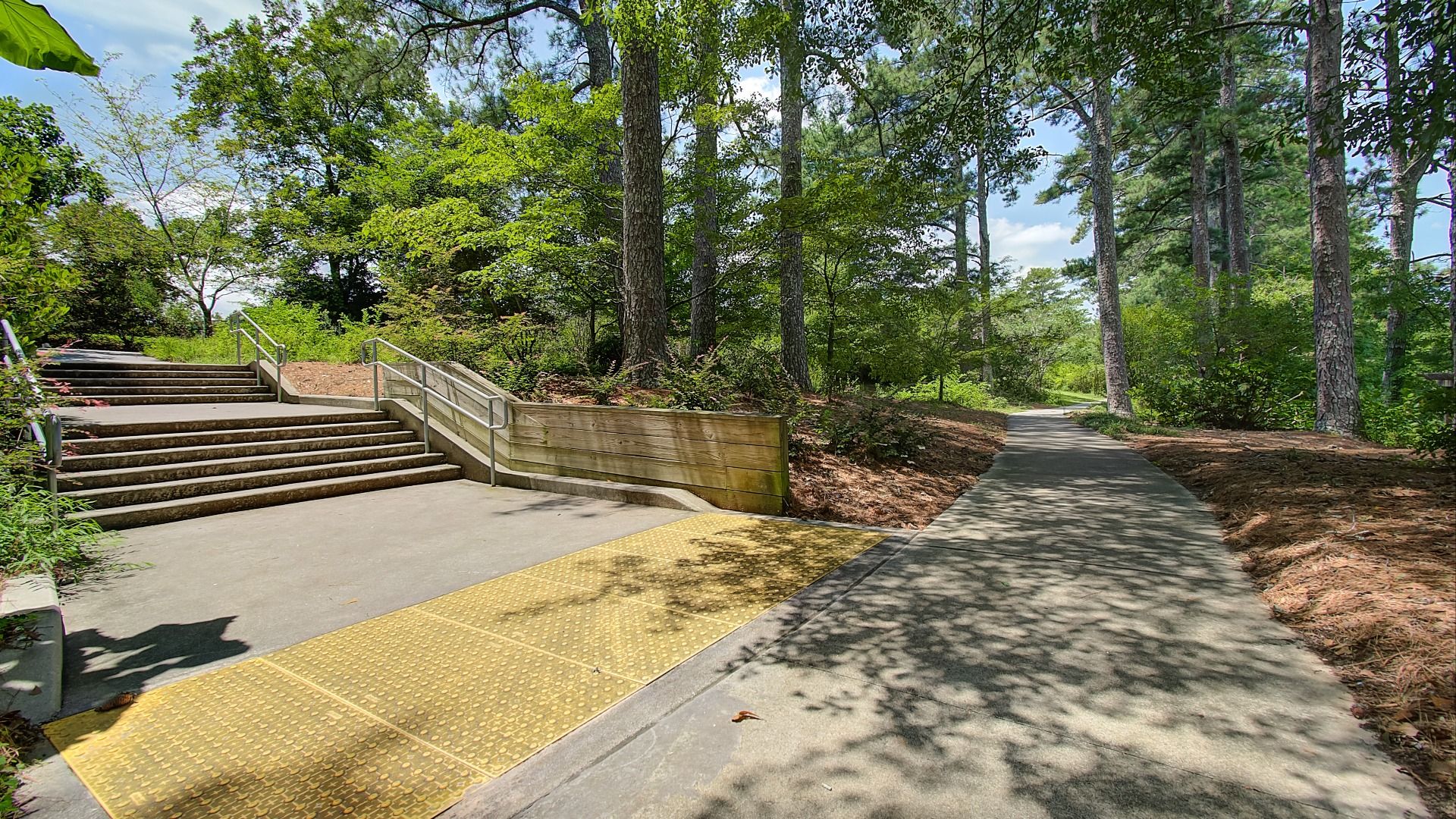 Paved community walking trail through peaceful natural surroundings near Hamilton Lakes in Loganville, GA.