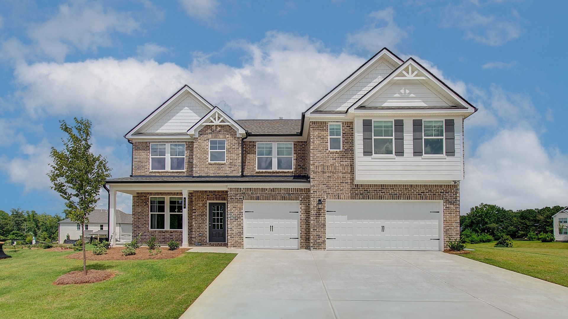 Rosemary II 4-sided brick home with siding accent and three car front-entry garage at Westwind Estates in Hampton, GA.