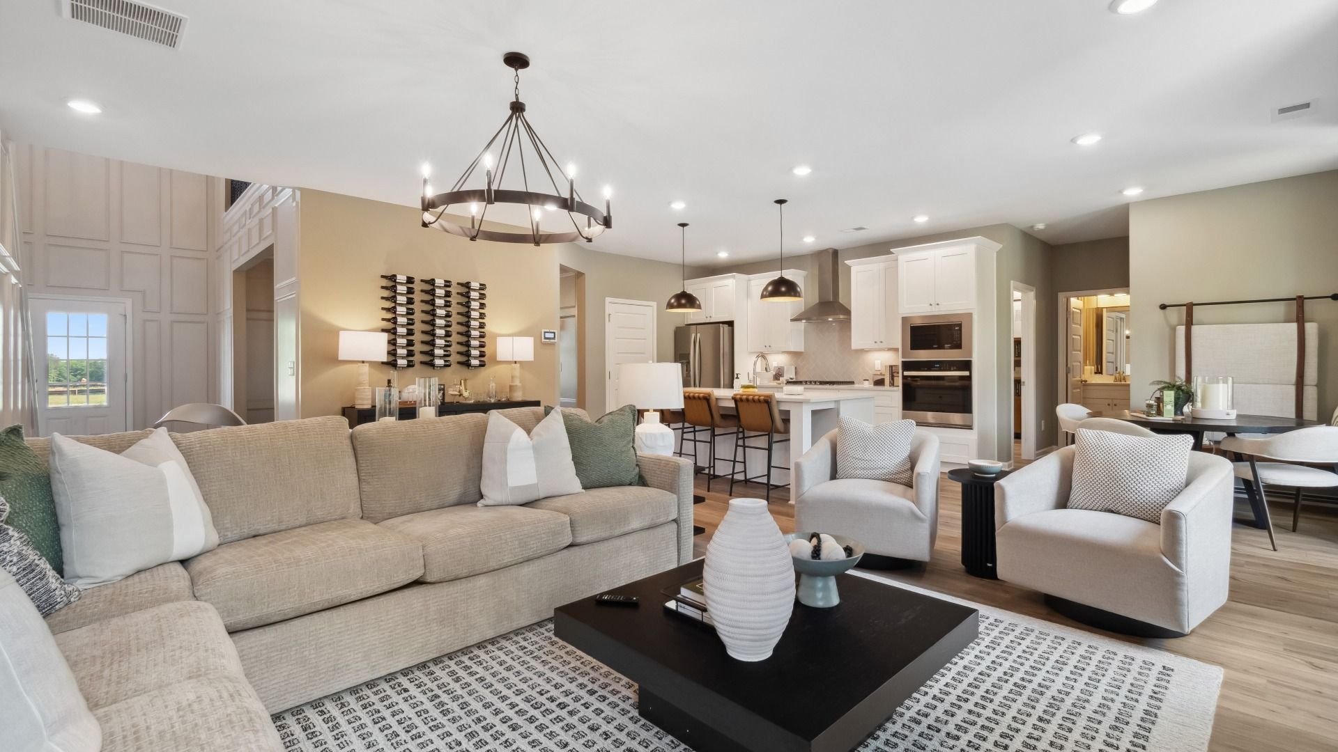 Family room with ample seating and open connection to kitchen and breakfast area at Westwind Estates in Hampton, GA.