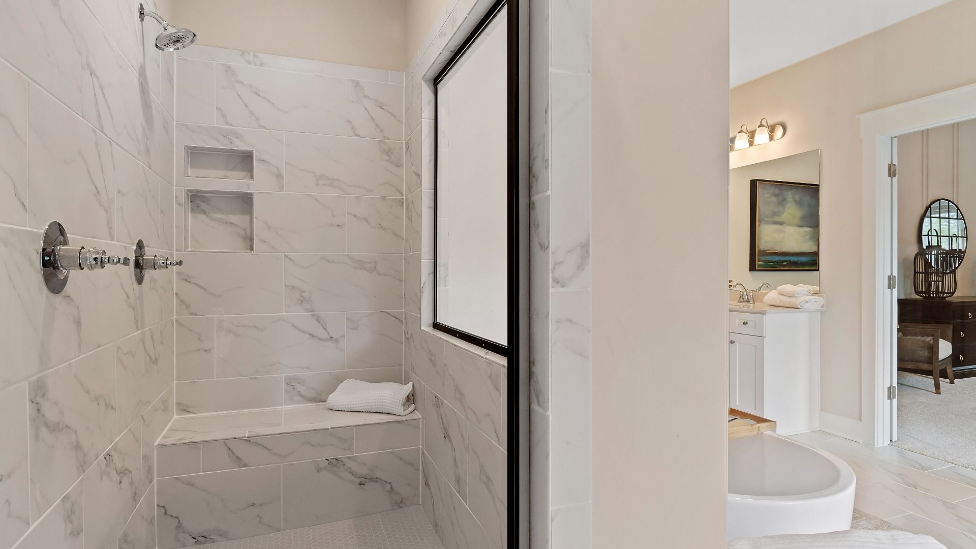 Primary bath with walk-in tiled shower and contemporary design at new construction single-family home in Senoia, GA.