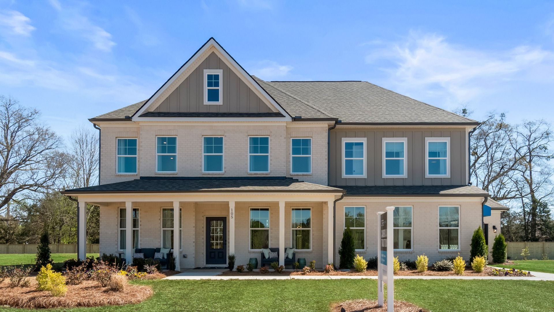 Stonefield two-story estate-sized home with covered entry, side-entry garage, and brick-dominant exterior at Brighton.