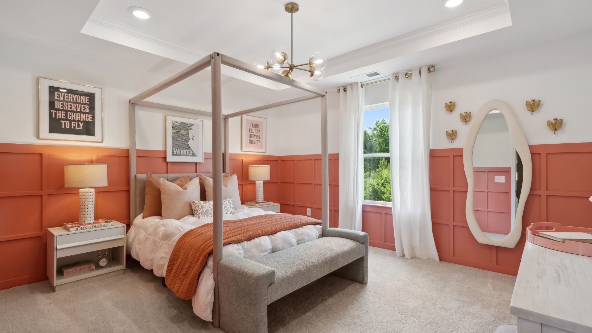 Generously-sized secondary bedroom with tray ceiling, carpet floors, and large window at Westwind Estates in Hampton, GA.