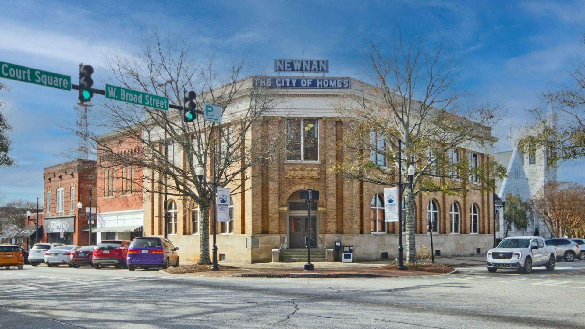 Carnegie Library featuring the iconic “Newnan, The City of Homes” signage in Newnan Town Square near Daybreak in Newnan, GA.