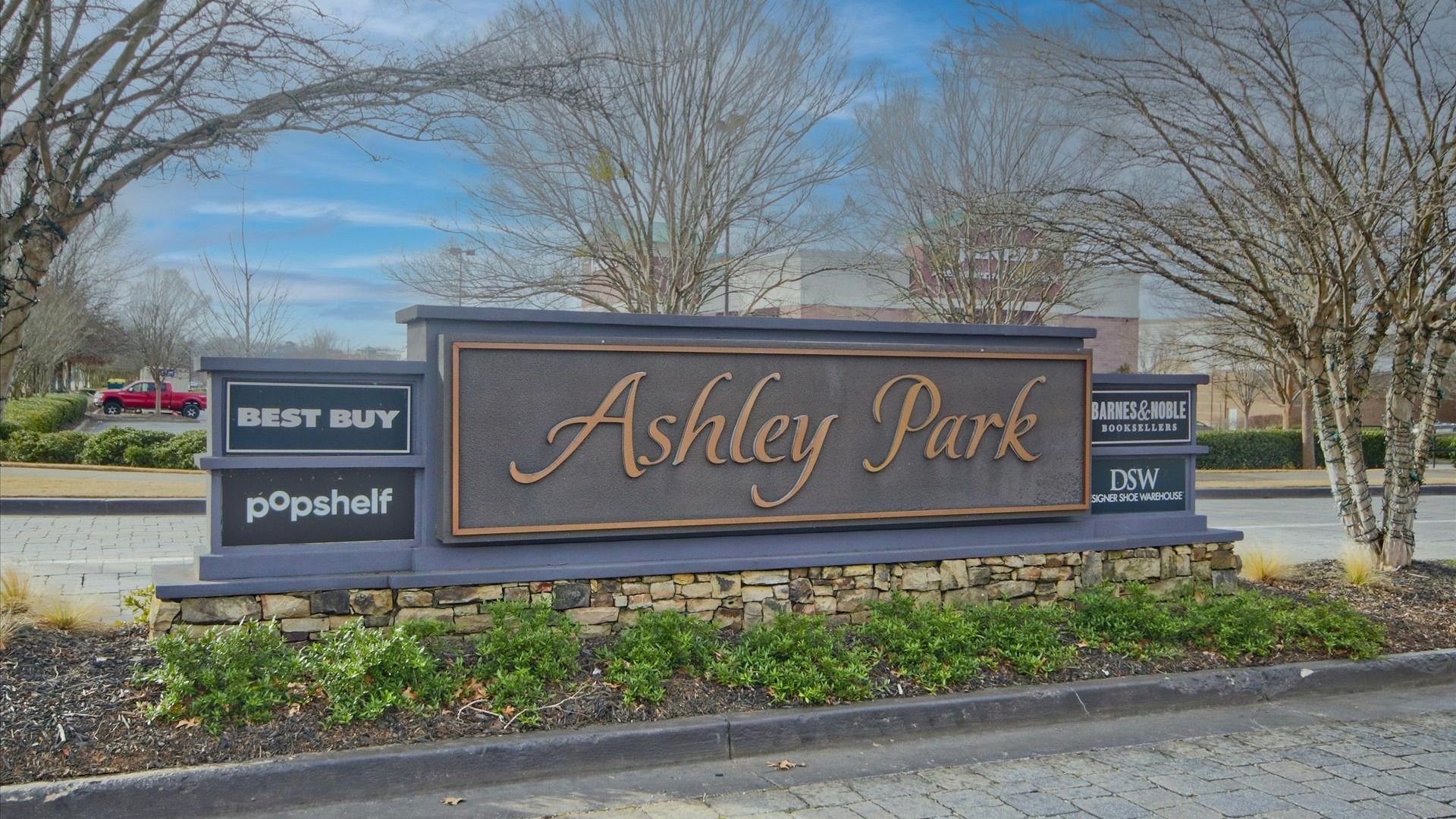 Ashley Park Shopping Center entrance sign in Newnan, GA near Daybreak new construction townhome community.