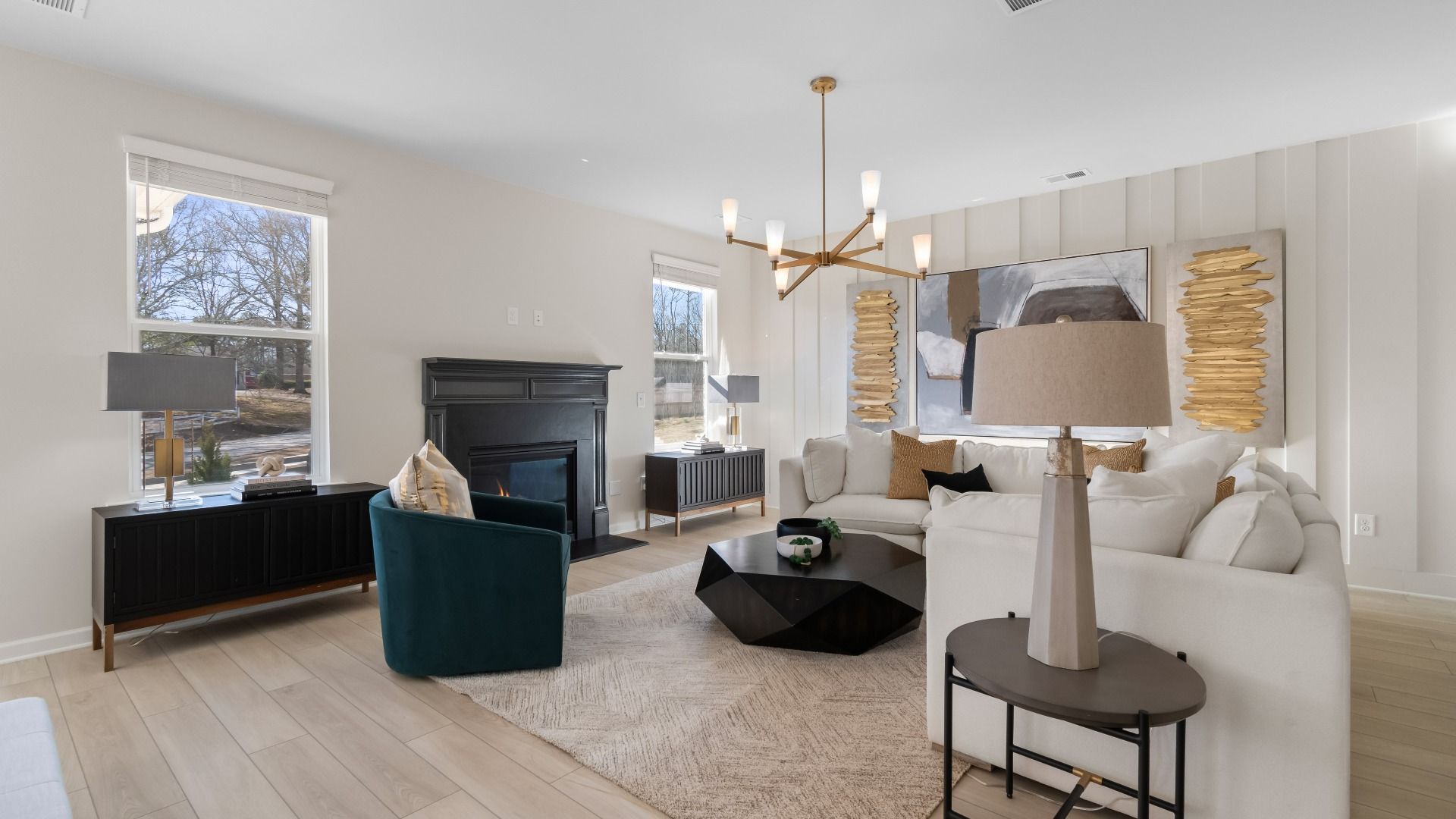Open family room with spacious layout, natural light, gas fireplace, and LVP flooring in the Ridgewood at Abbotts Crossing.