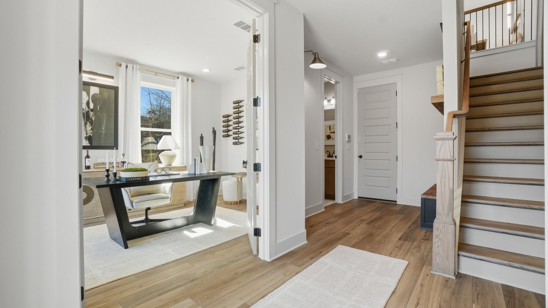 Seaton entry into open foyer with access to stairs and view to office at Barrett Pointe in Kennesaw, GA.