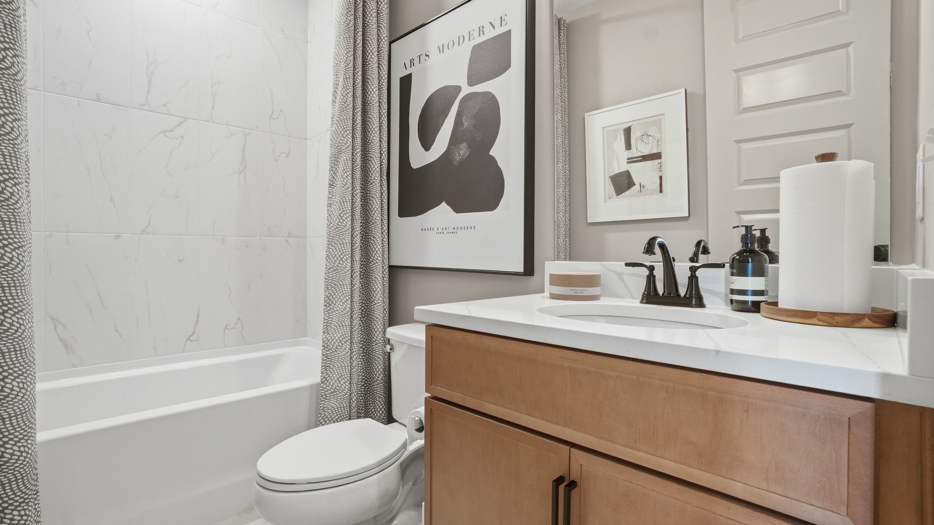 Secondary bath with shower-tub combo and clean modern finishes in the Seaton at Barrett Pointe in Kennesaw, GA.