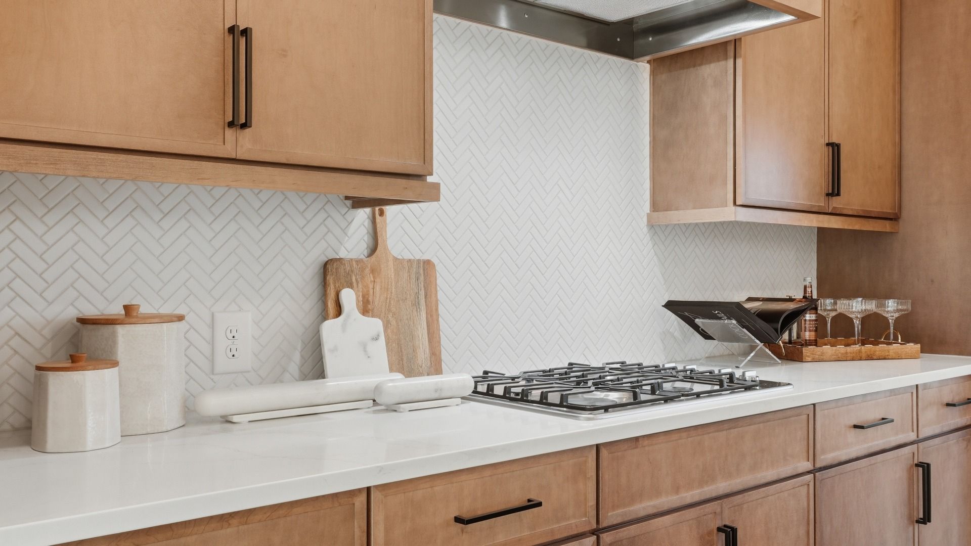 Luxury kitchen with modern tile backsplash, wooden cabinetry, and contemporary design in the Seaton at Barrett Pointe.