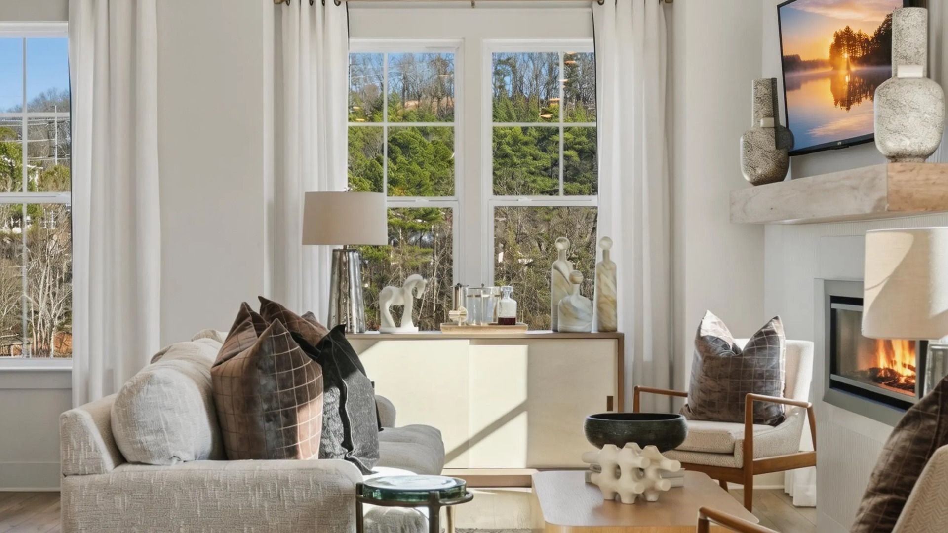Bright family room with large windows, neutral palette, and modern finishes in the Seaton at Barrett Pointe in Kennesaw, GA.