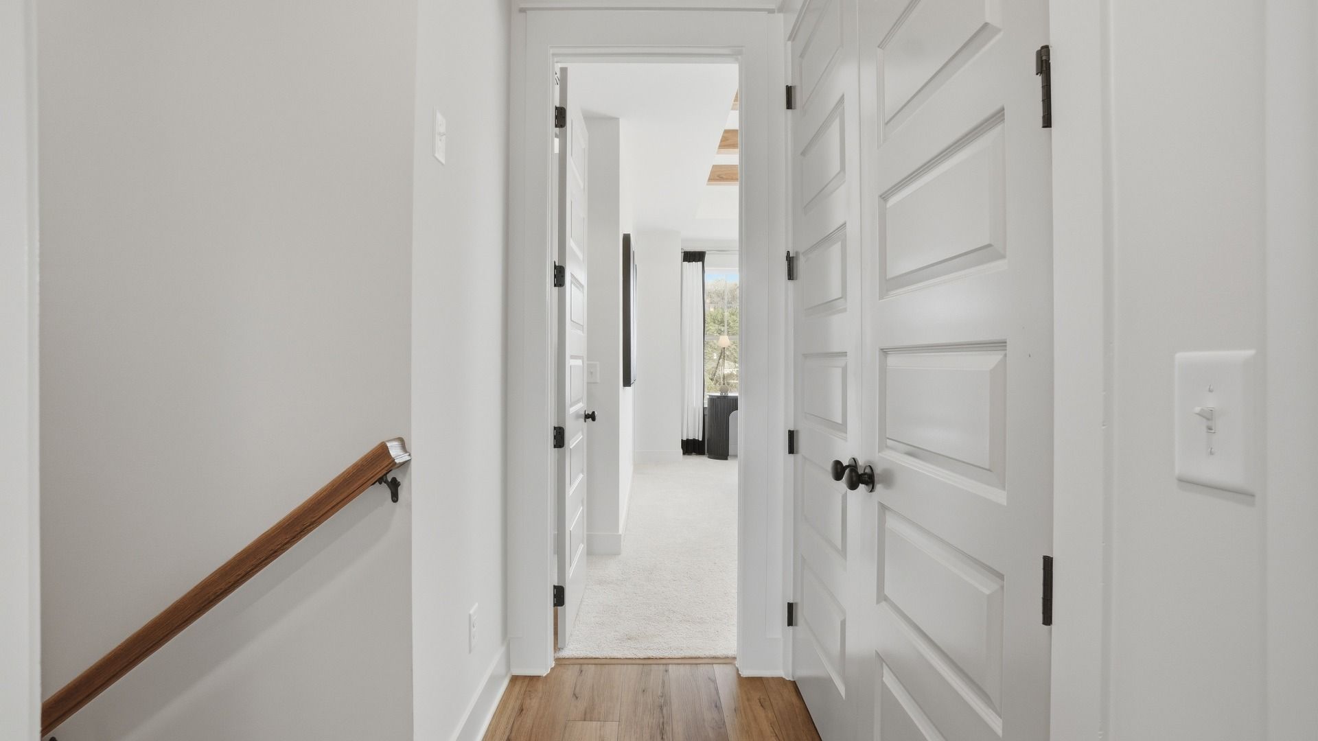 Upstairs Landing with LVP flooring and open hallway in the Seaton new construction townhome at Barrett Pointe.