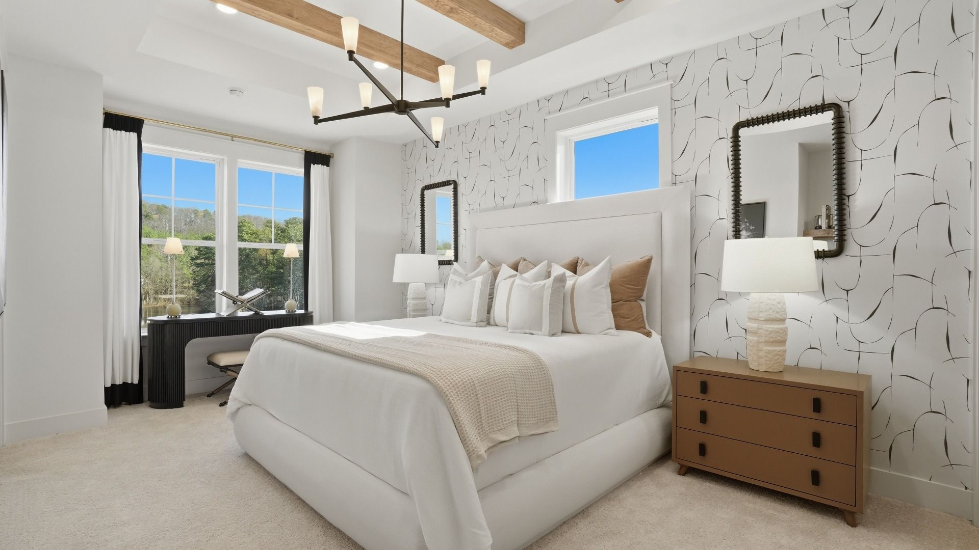 Bright primary suite with beamed ceiling, carpet flooring, and natural light in the Seaton at Barrett Pointe in Kennesaw, GA.