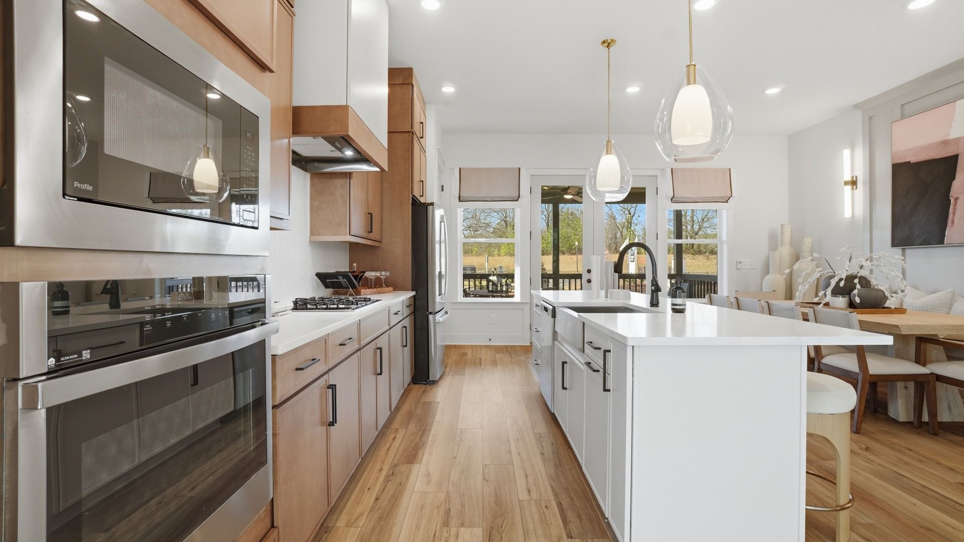 Open kitchen featuring abundant storage, spacious island, and luxury flooring at Barrett Pointe in Kennesaw, GA.