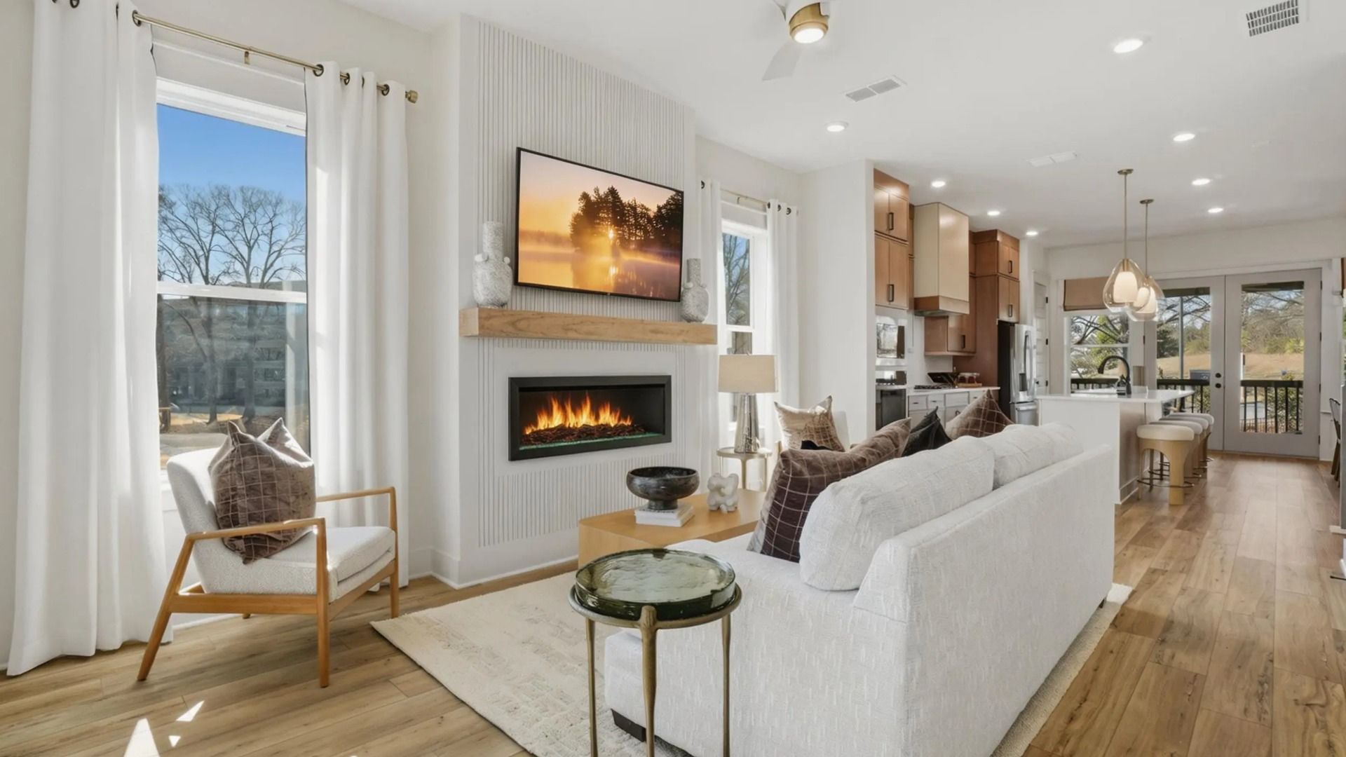 Open family room featuring large windows and comfortable gathering space in new construction townhome in Kennesaw, GA.