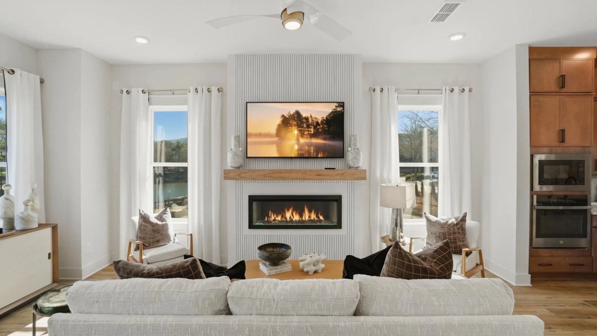 Spacious family room with statement fireplace wall and natural light in new construction townhome in Kennesaw, GA.