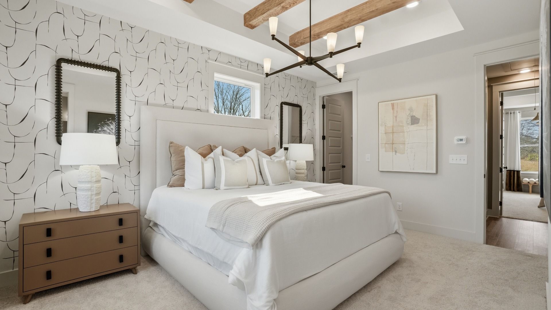 Spacious bedroom with wood beamed ceiling and natural light in new construction townhome in Kennesaw, GA.