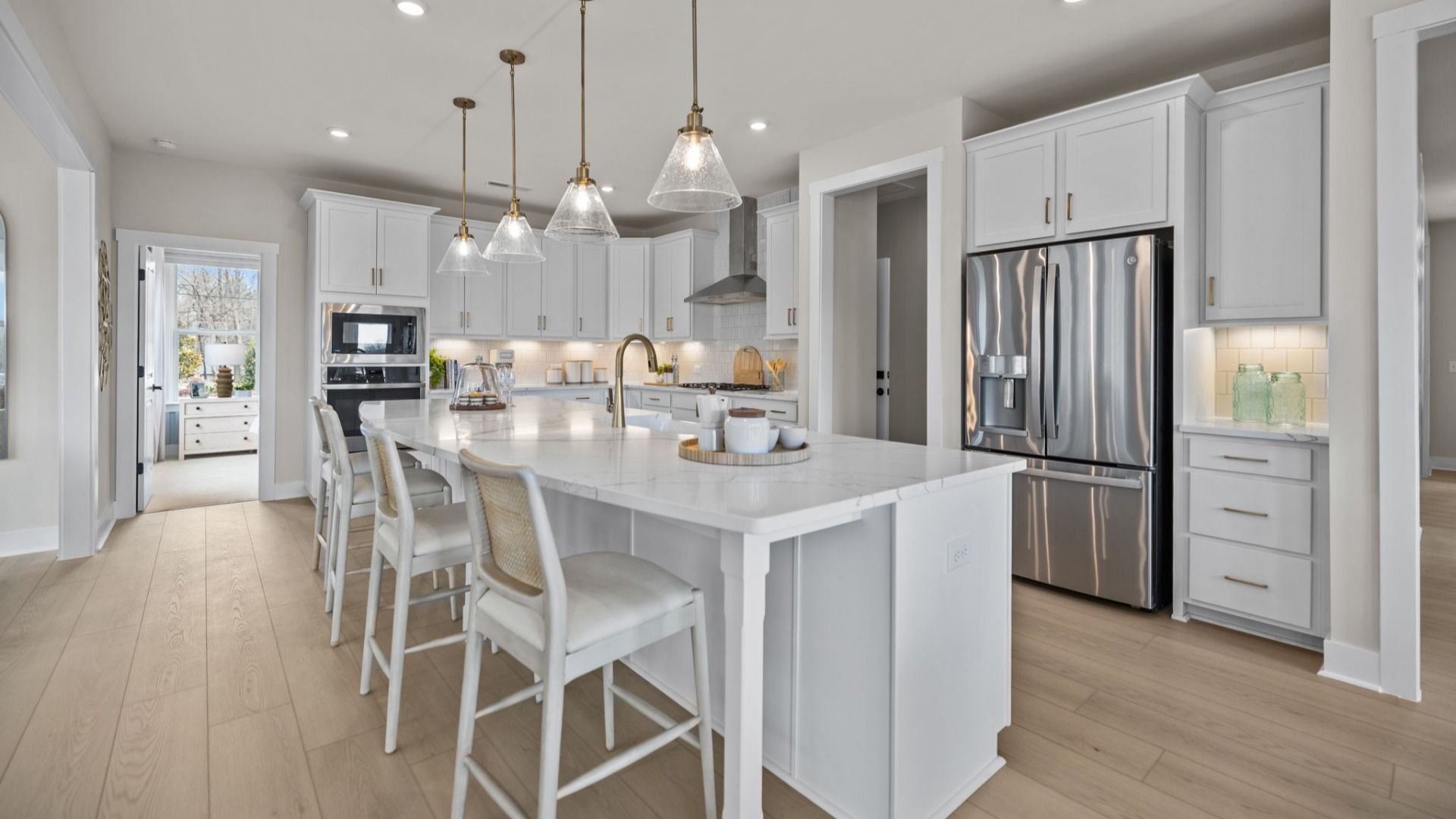 The Stonefield Home Plan by DRB Homes in Belmont, NC. - Kitchen featuring an oversized bar and butler's panty