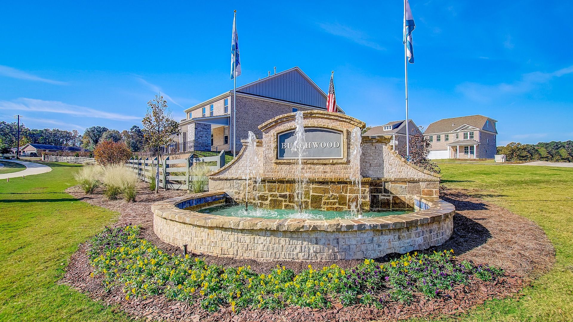 Stone monument entrance sign with fountain welcoming residents to Burchwood community in Stockbridge, GA.