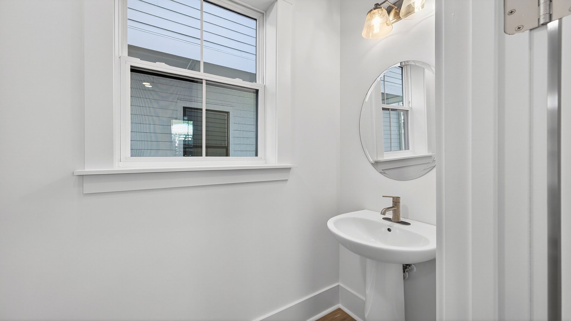 Convenient half bathroom in the Seabrook home plan with elegant fixtures and modern style.