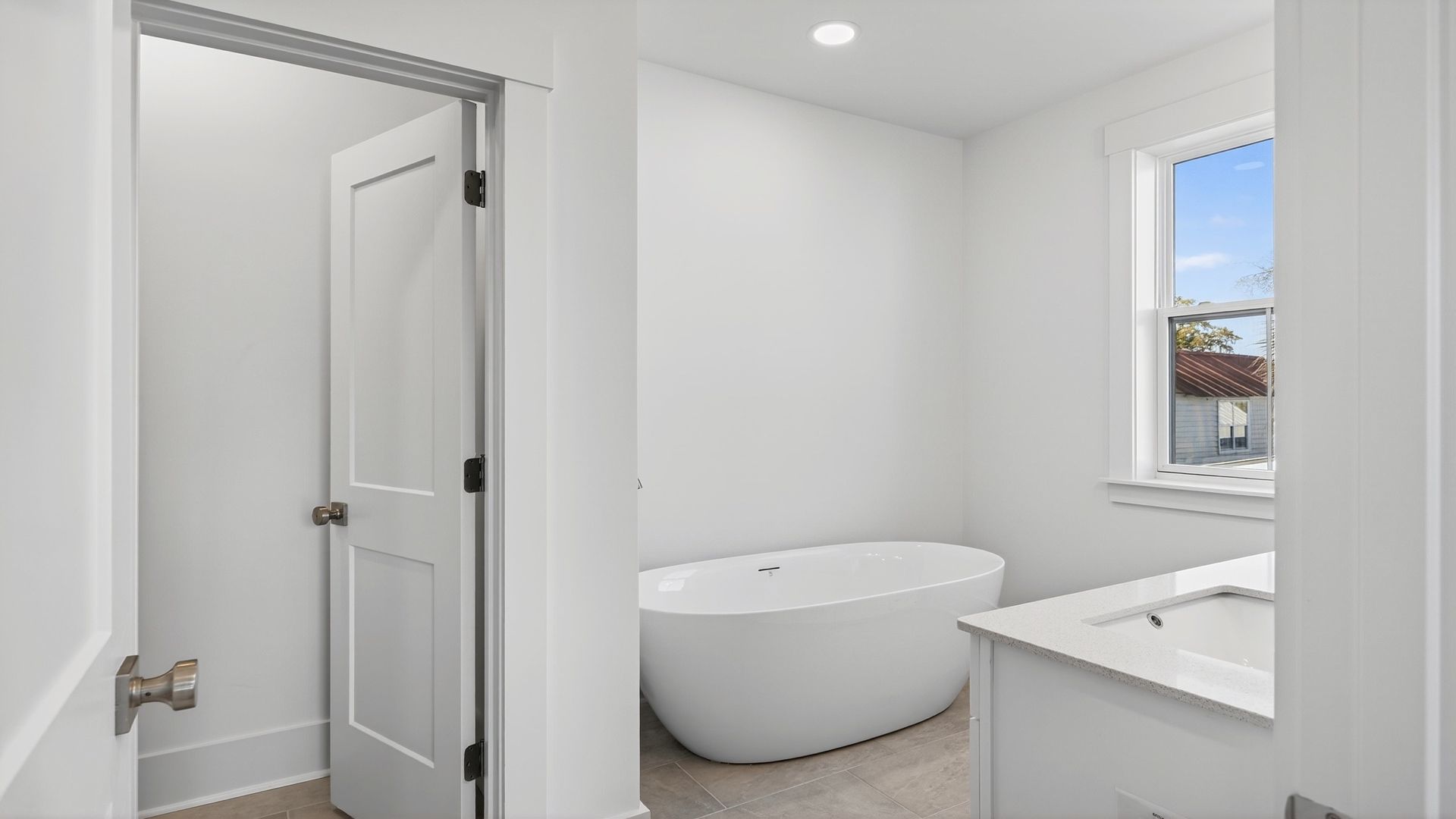 The Seabrook primary bathroom includes a soaking tub, glass-enclosed shower, and elegant details.