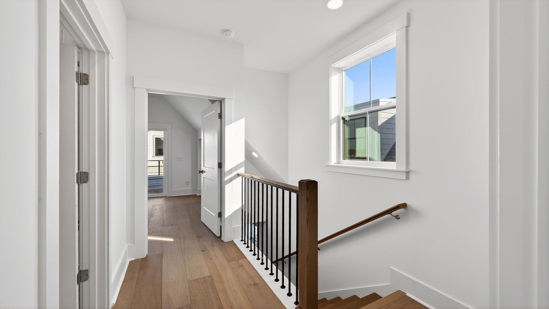 Third-floor hallway in the Seabrook home featuring hardwood flooring and easy access to bedrooms.