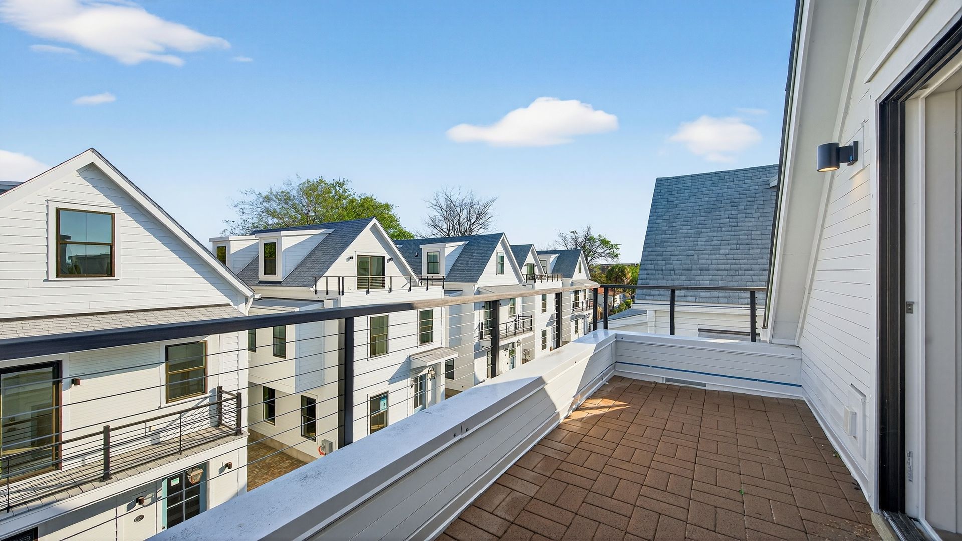 Private balcony in the Seabrook home offering outdoor living space and Charleston neighborhood views.