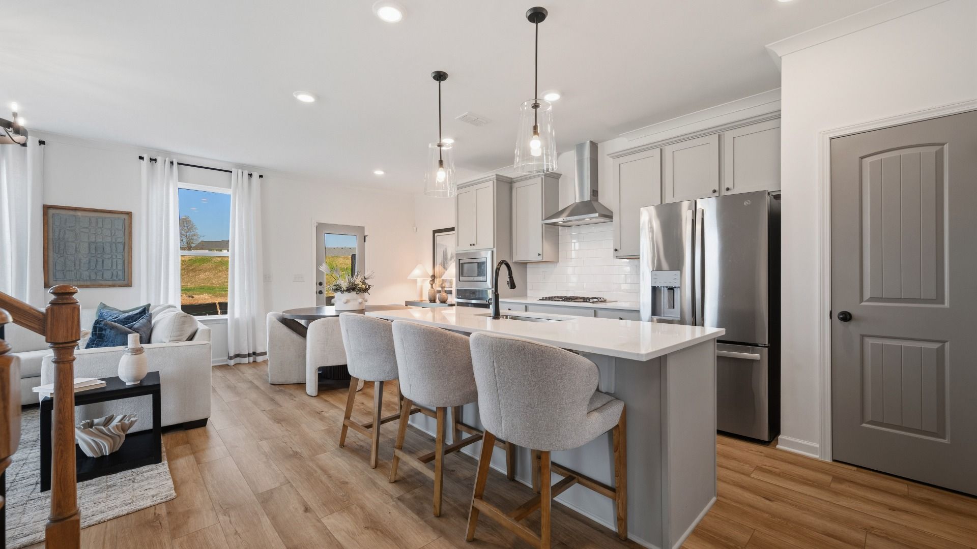 Bright open kitchen with quartz island and modern finishes in Langley Overlook townhome in Loganville, GA.